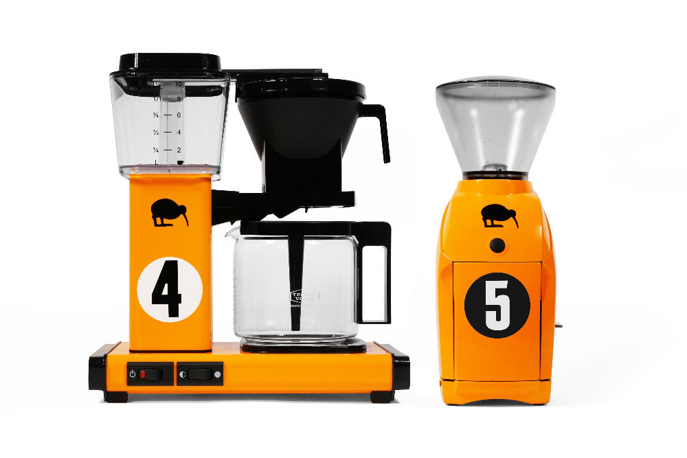Premium PSD  A brown and orange coffee maker with a cup of coffee